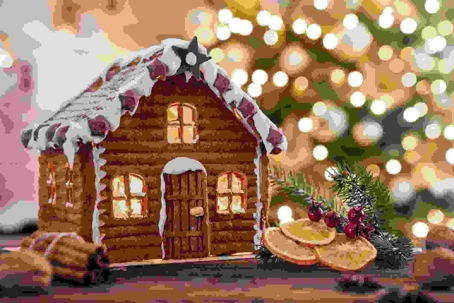 gingerbread house in front of christmas tree