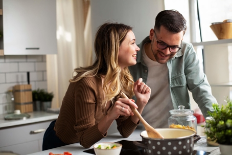 man and woman cooking together