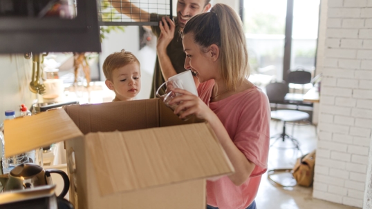 family unpacking kitchen after move